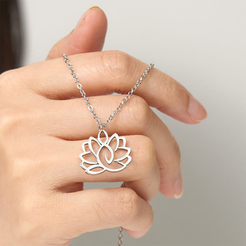 Hollow Lotus Necklace – Silver lotus pendant held on hand showing petal detail, spiritual purity jewelry