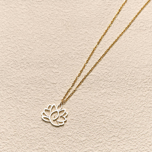 Hollow Lotus Necklace – Two-tone gold chain with silver lotus pendant on cream, enlightenment jewelry
