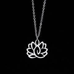 Hollow Lotus Necklace – Silver openwork lotus pendant on chain against black, enlightenment jewelry