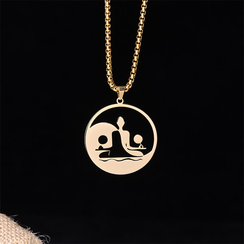 Yin Yang Buddha Stainless Steel Necklace – front black background burlap gold Buddha yin yang pendant, dark studio