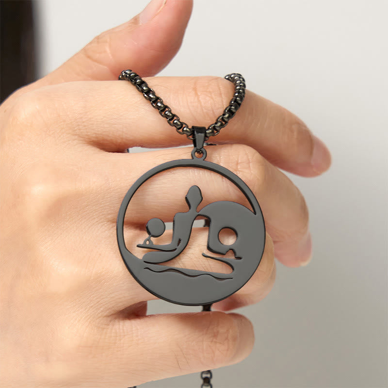 Yin Yang Buddha Stainless Steel Necklace – held hand light background black Buddha yin yang pendant scale, hand-held