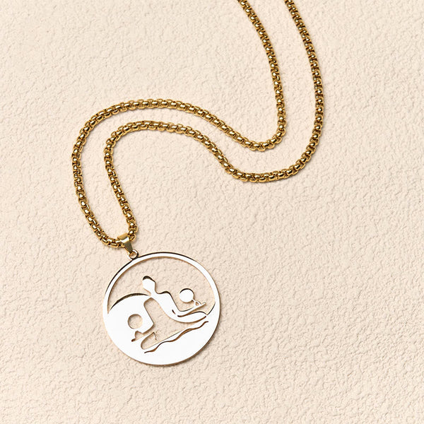Yin Yang Buddha Stainless Steel Necklace – flatlay cream texture gold chain round Buddha yin yang pendant, flat-lay