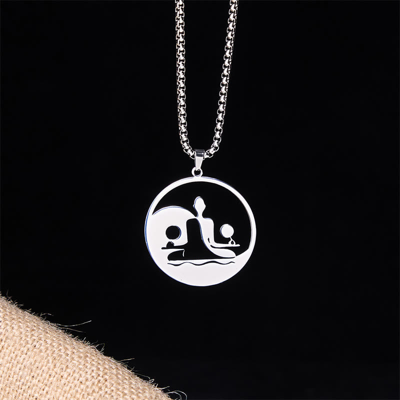 Yin Yang Buddha Stainless Steel Necklace – front black background burlap silver Buddha yin yang pendant, dark studio