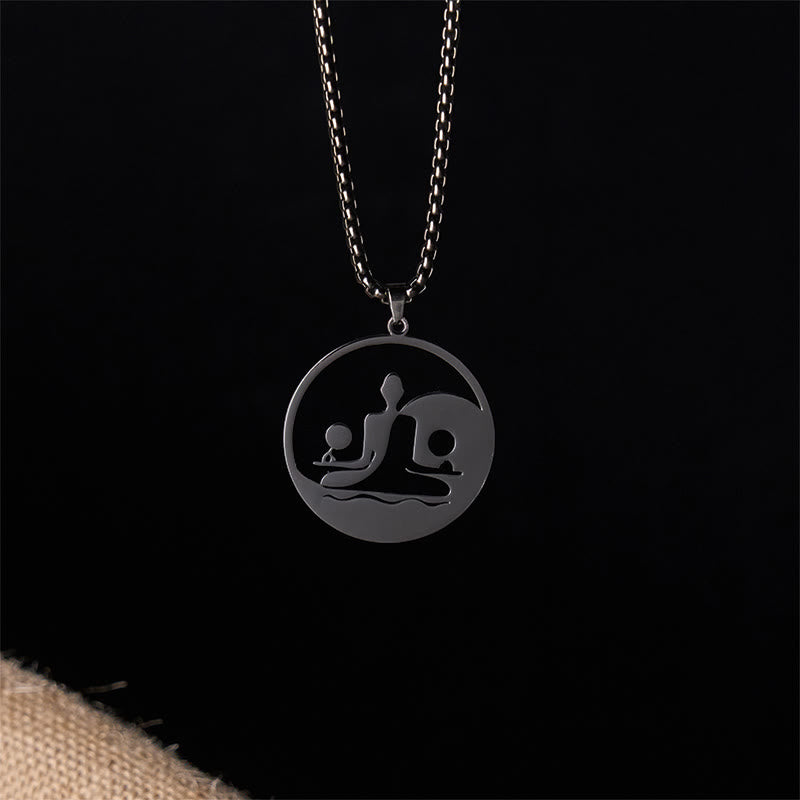 Yin Yang Buddha Stainless Steel Necklace – front black background burlap black Buddha yin yang pendant, dark studio