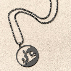 Yin Yang Buddha Stainless Steel Necklace – flatlay cream texture black chain round Buddha yin yang pendant, flat-lay