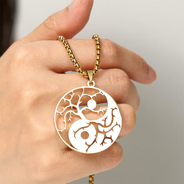 Yin Yang Branches Necklace – Gold pendant held by hand, balance necklace