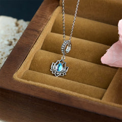 S925 sterling silver lotus pendant with blue moonstone and crystal-accented bail on velvet, spiritual necklace