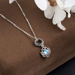 Silver lotus necklace with glowing moonstone teardrop stone, oxidized bail detail on suede, boho jewelry