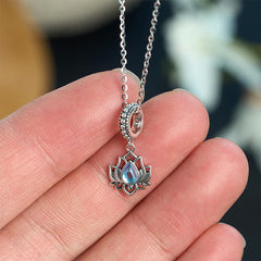 Sterling silver lotus pendant with blue flash moonstone held in hand, 925 stamped bohemian spiritual jewelry