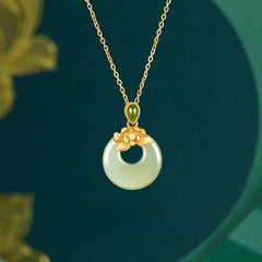 Hetian Jade Lotus Peace Buckle Necklace - jade disc with gold lotus bail on teal backdrop, Graceful