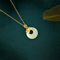 Hetian Jade Lotus Peace Buckle Necklace - diagonal view of bi-disc pendant and gold chain, Luminous