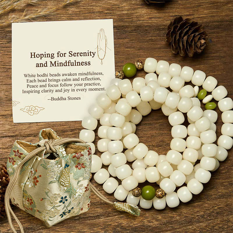 Bodhi Seed Lotus Mala - coiled white beads with patterned bodhi seed accents, meditation tool