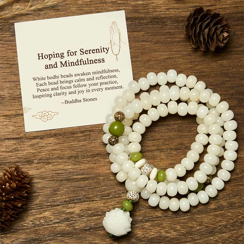 Bodhi Seed Lotus Mala - 108 white bodhi beads with lotus pendant on dark wood, mindfulness flat lay