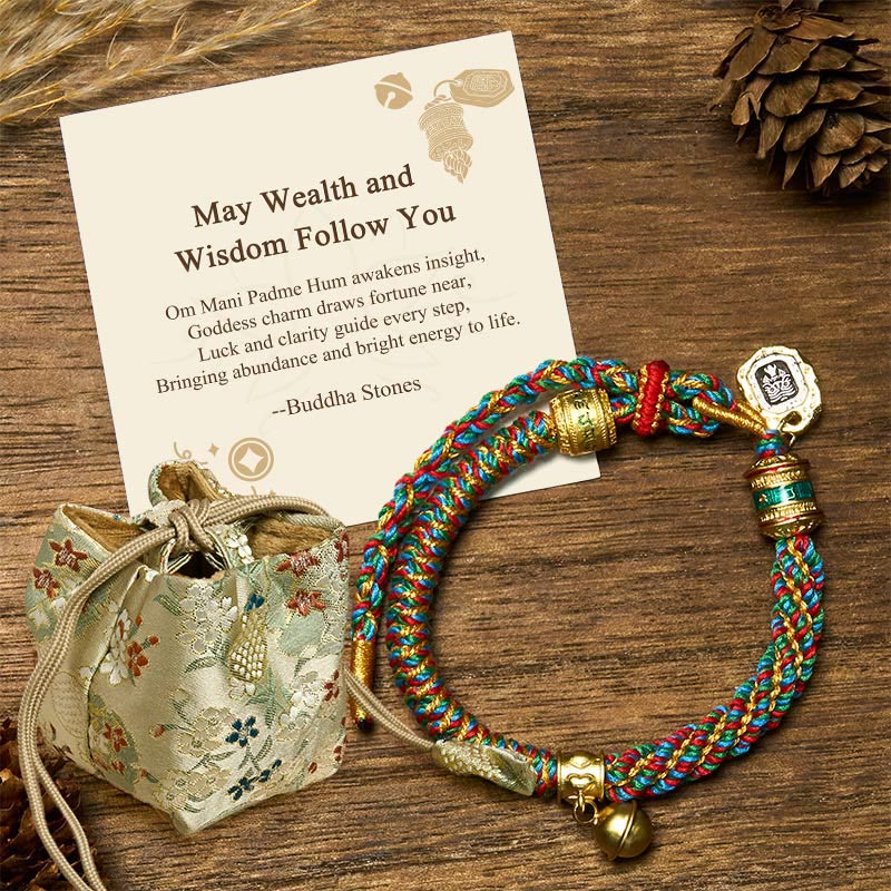 Zakiram Om Mani Padme Hum String Bracelet – braided rope with metal beads and silk pouch on wooden surface, mantra bracelet
