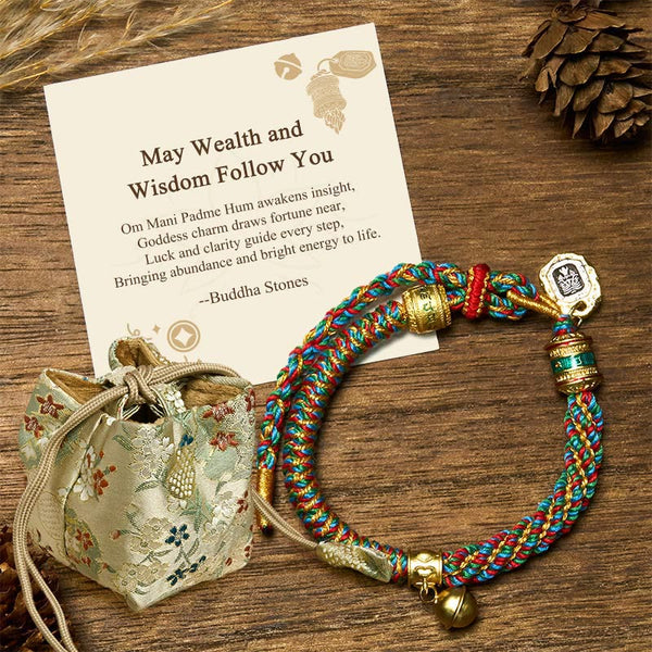 Zakiram Om Mani Padme Hum String Bracelet – braided rope with metal beads and silk pouch on wooden surface, mantra bracelet