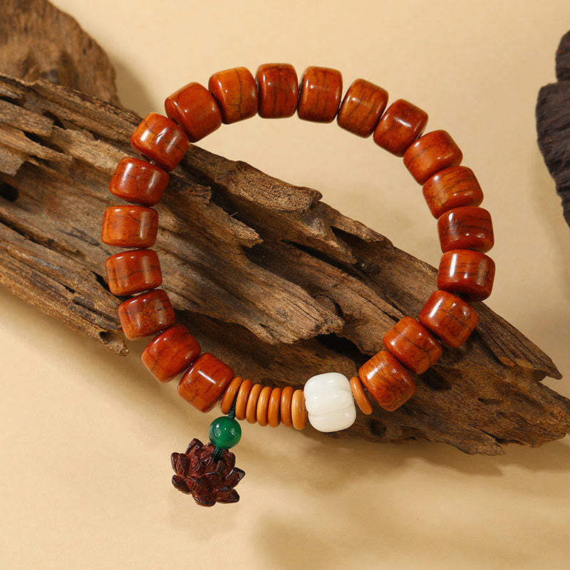 Bone Beads Lotus Peace Buckle Enlightenment Bracelet – draped on driftwood showing lotus pendant detail, organic