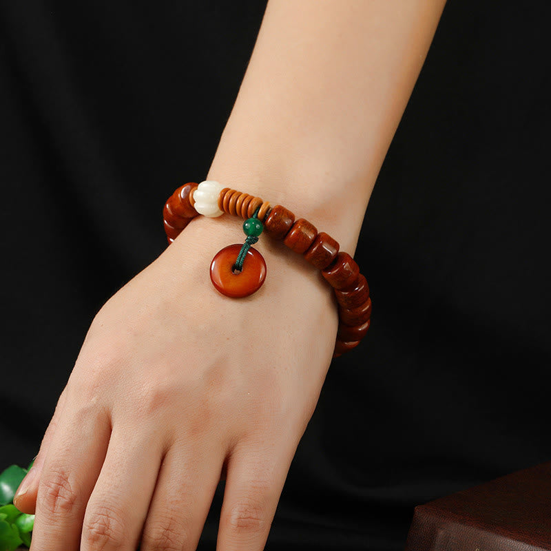 Bone Beads Lotus Peace Buckle Enlightenment Bracelet – worn on wrist showing carved lotus bead and peace disc, mindful