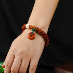 Bone Beads Lotus Peace Buckle Enlightenment Bracelet – worn on wrist showing carved lotus bead and peace disc, mindful
