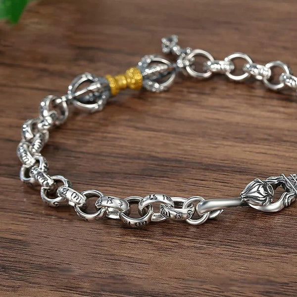 Copper Vajra Om Mani Padme Hum Bracelet – close-up macro of antique silver links and gold-accented vajra on walnut