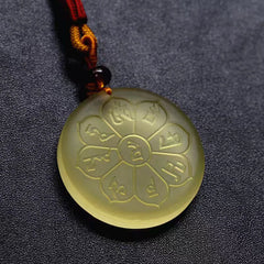 Liuli Crystal Wealth God Mantra Abundance Eight-Petal Necklace – macro of yellow liuli pendant mantra engravings, texture