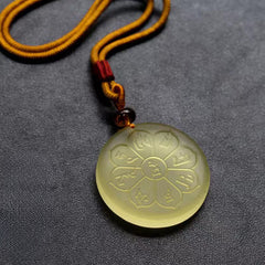 Liuli Crystal Wealth God Mantra Abundance Eight-Petal Necklace – yellow liuli pendant with mantra carving, front closeup