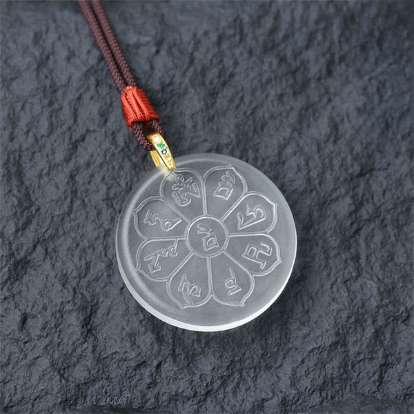 Liuli Crystal Wealth God Mantra Abundance Eight-Petal Necklace – clear liuli pendant with gold clasp on slate, detail shot