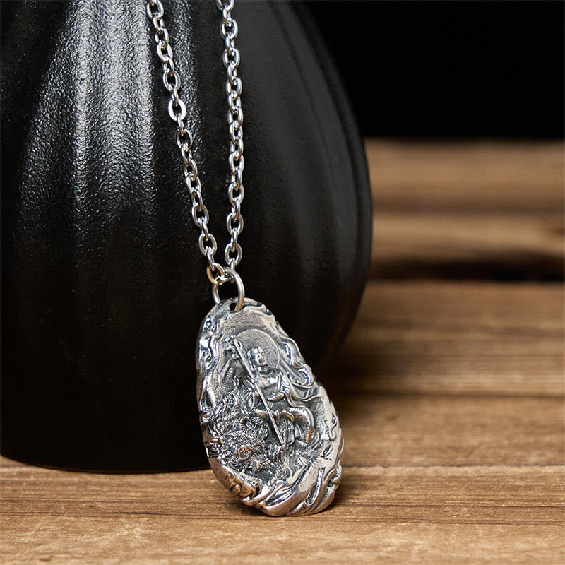 Copper Ksitigarbha Pendant Necklace – leaning against black ceramic vase, dramatic studio light