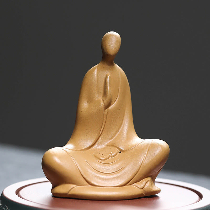 Ceramic Formless Buddha Prayer Statue – front view, warm tan ceramic with prayer hands, on display stand, earthy tone