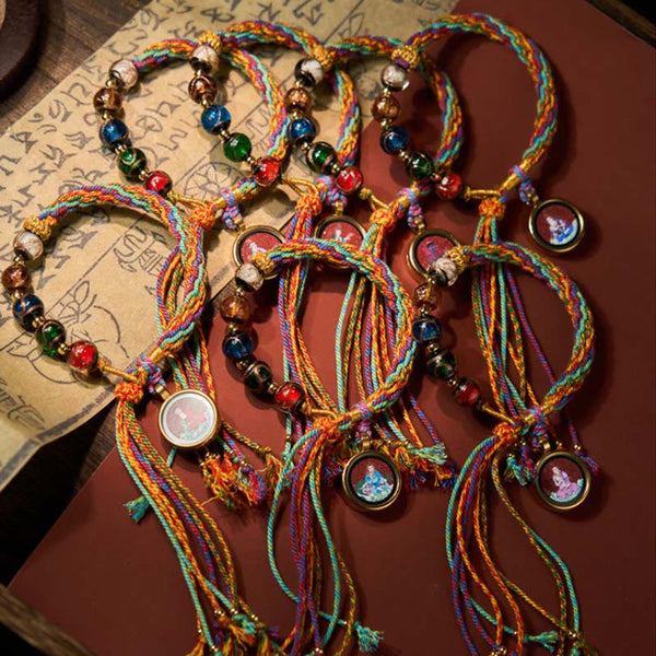 Zodiac Natal Buddha Cinnabar Bracelet – close-up of string weaving between, cinnabar bracelet, zodiac Buddha, red string