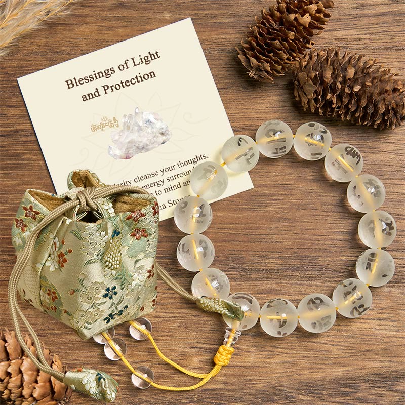White Crystal Om Mani Padme Hum Bracelet – top-down view with brocade pouch and blessing card