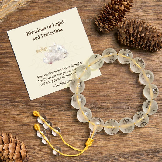 White Crystal Om Mani Padme Hum Bracelet – flat lay on wood with pine cones and blessing card, crystal healing