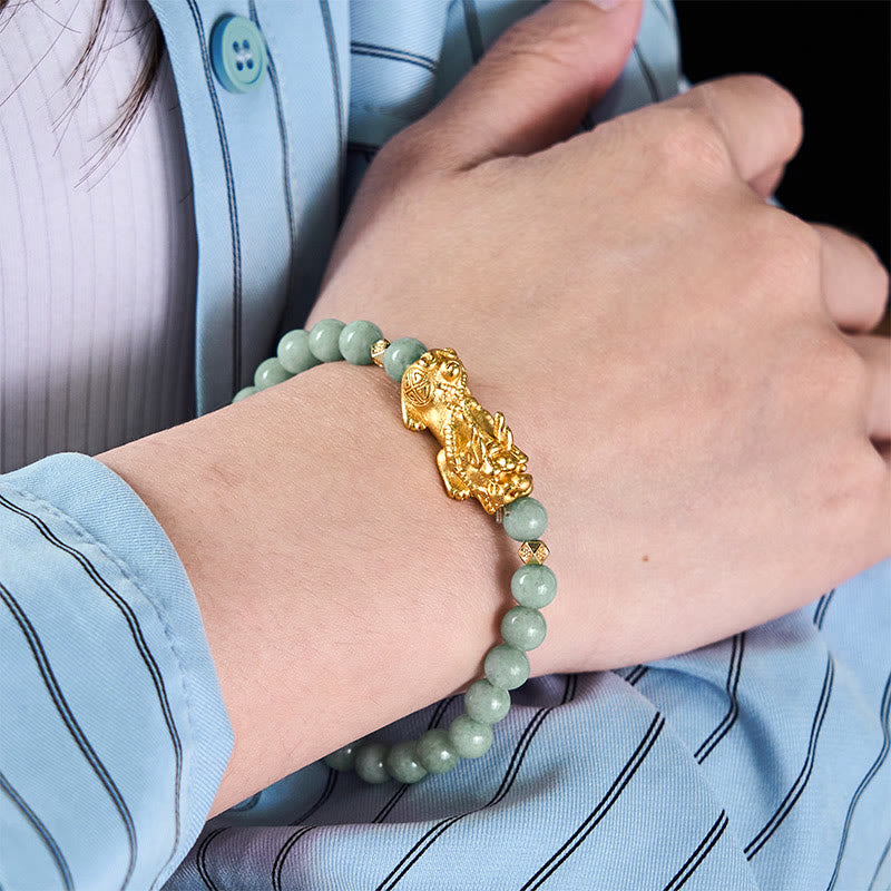 Golden Pi Xiu Charm Jade Prosperity Beaded Bracelet – Wrist model wearing green jade and gold Pi Xiu bracelet, blue shirt