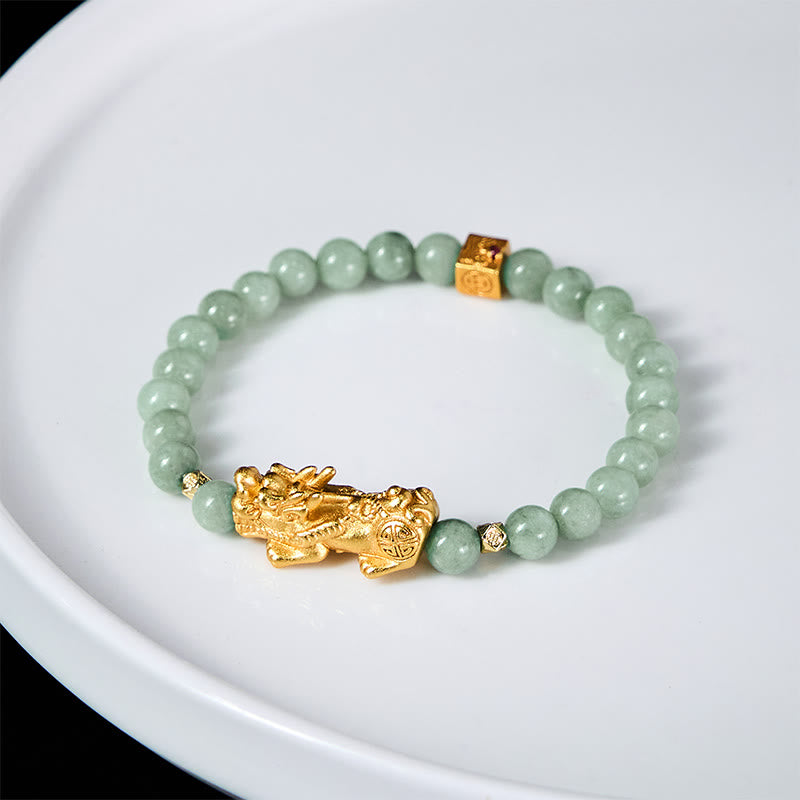 Golden Pi Xiu Charm Jade Prosperity Beaded Bracelet – Green jade bracelet with gold Pi Xiu on white plate, bright background