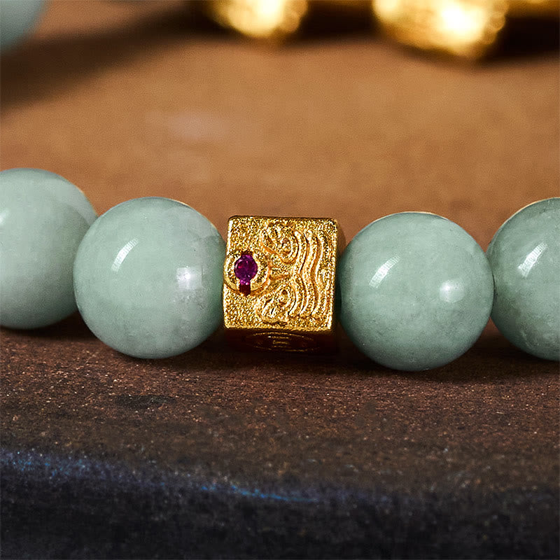 Golden Pi Xiu Charm Jade Prosperity Beaded Bracelet – Close-up of gold spacer bead with red gem and phoenix pattern detail