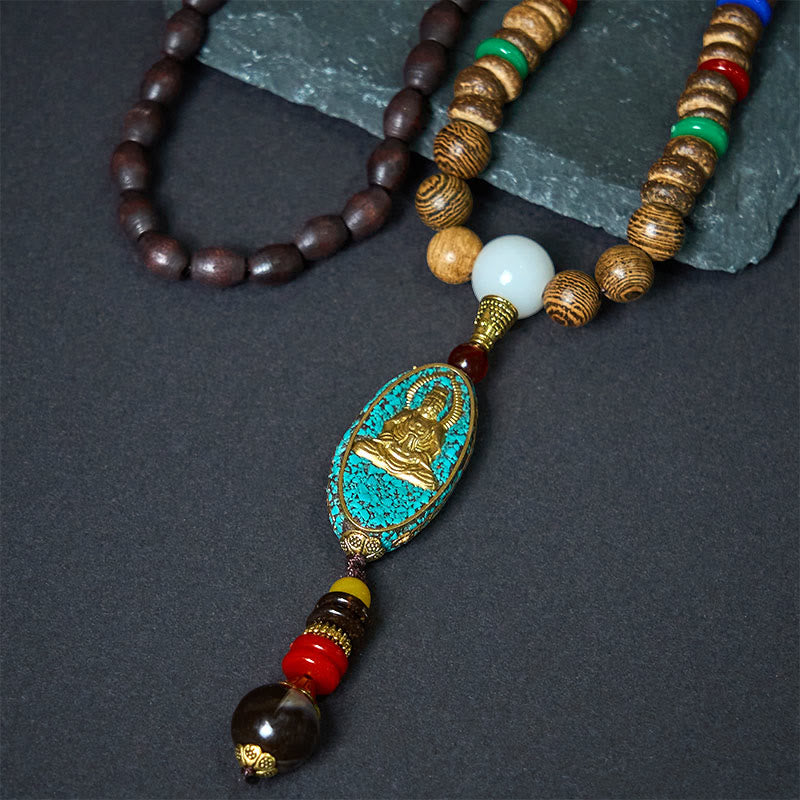 Vintage Nepal Avalokitesvara Necklace – angled closeup of turquoise pendant against gray stone, intricate carving