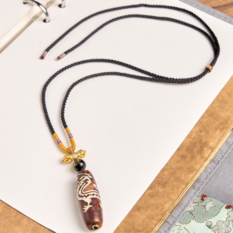 Tibetan Agate Nine-Eye Dzi Dragon Protection Necklace – close-up of polished agate dzi bead surface, Healing