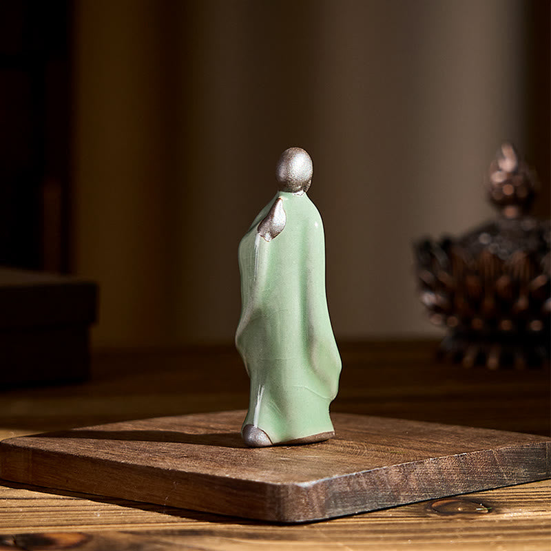 Meditation Monk Ceramic Statue – hand holding monk statue against white, monk statue, serenity decor, ceramic figurine