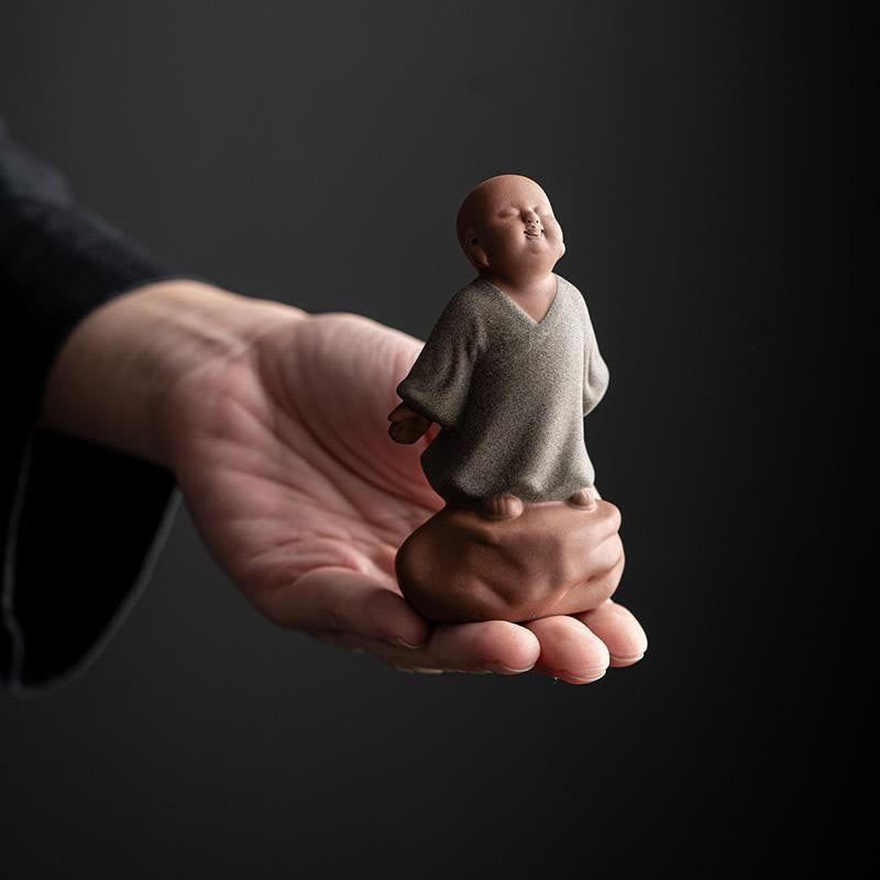 Looking Up Resting Monk Ceramic Statue Compassion Home Decor – back view monk robe folds, detailed ceramic craftsmanship