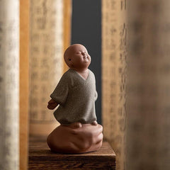 Looking Up Resting Monk Ceramic Statue Compassion Home Decor – statue on wooden shelf, warm home compassion decor