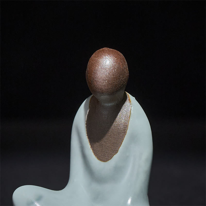 Ceramic Formless Buddha Meditating Statue – macro closeup of head and chest, brown matte texture, pale celadon glaze, detail shot