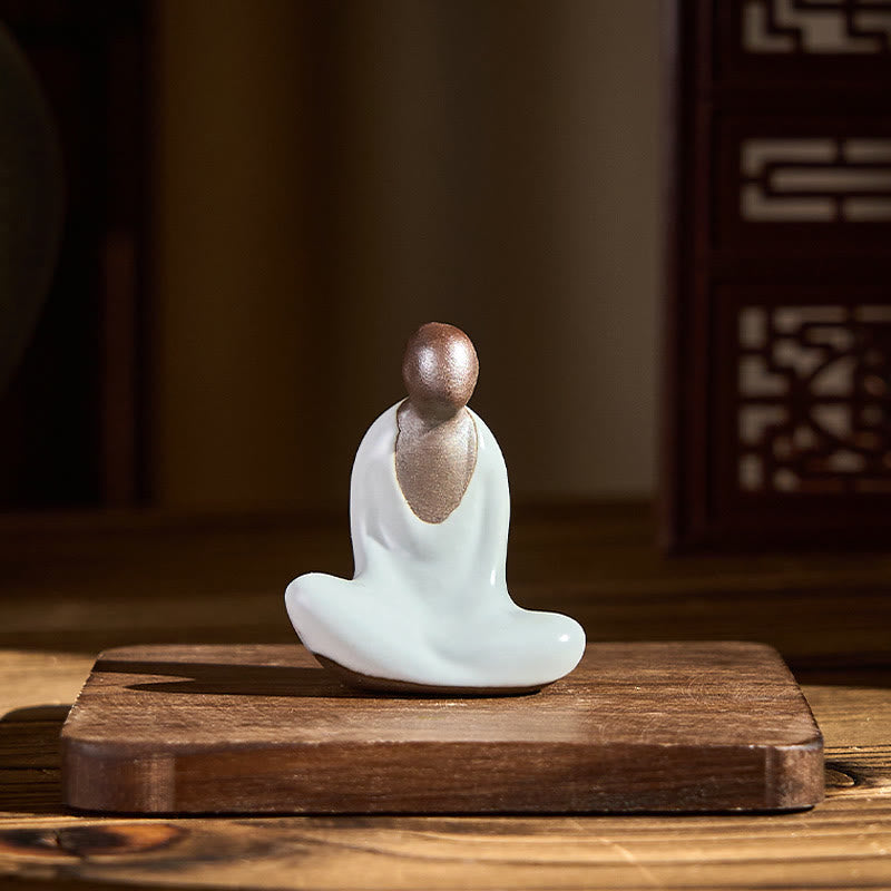 Ceramic Formless Buddha Meditating Statue – displayed on wooden stand in warm interior, Asian screen background, mindfulness altar