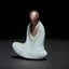 Ceramic Formless Buddha Meditating Statue – front view, white celadon glaze with brown head, dark studio backdrop, zen decor