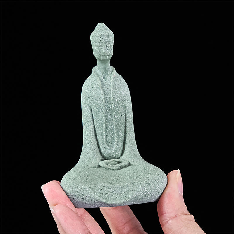Sandstone Meditation Buddha Desk Statue – held between fingers showing base, compact miniature