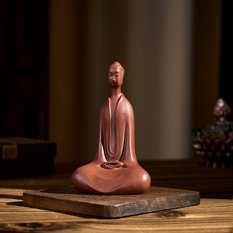 Purple Clay Formless Buddha Desk Decoration – Front on wood surface with soft bokeh in golden light, mindfulness
