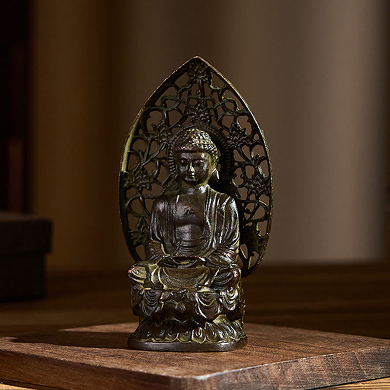 Tathagata Buddha Alloy Statue – Angled view on wooden surface showing draped robes, serenity