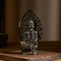 Tathagata Buddha Alloy Statue – Angled view on wooden surface showing draped robes, serenity