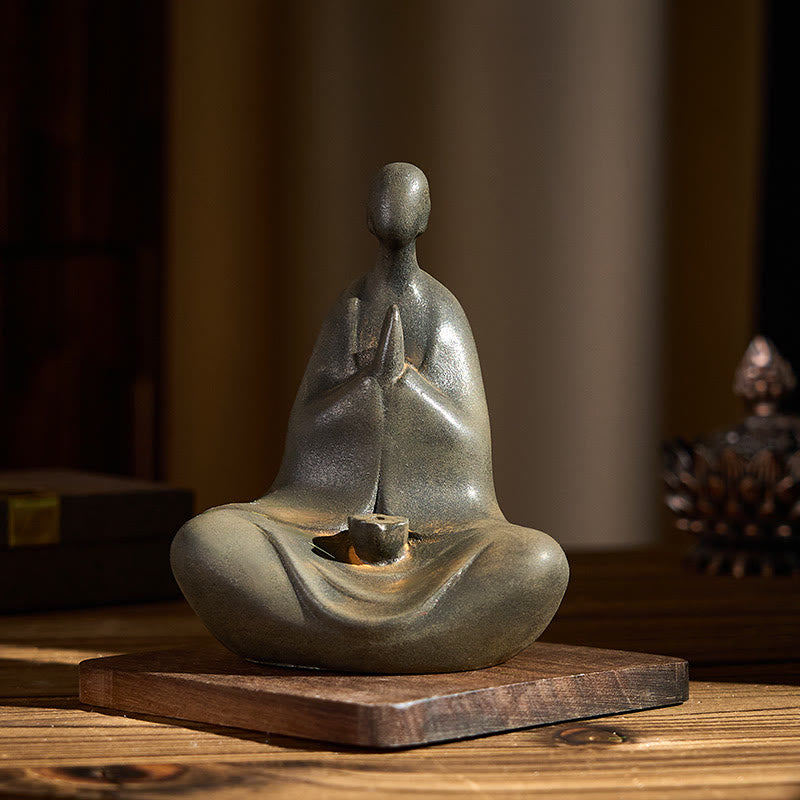 Iron Powder Formless Buddha Statue – front view on wooden table with books and crystal accents, peaceful ambiance