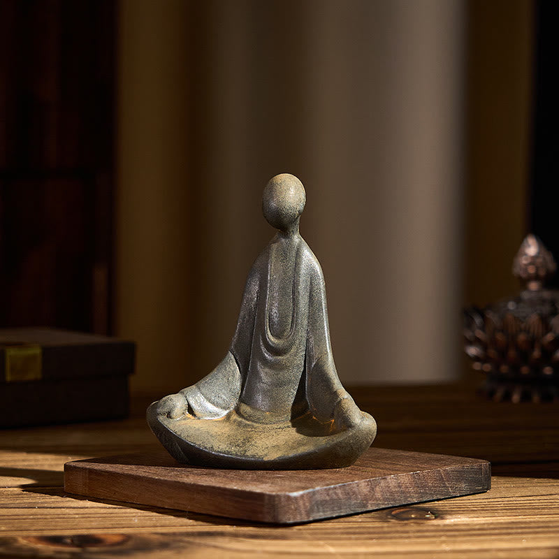 Iron Powder Sitting Formless Buddha Statue – front view on wood base, cozy interior, tranquility