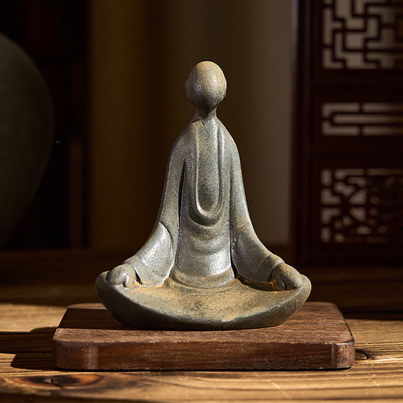 Iron Powder Sitting Formless Buddha Statue – front view on wooden base, warm room light, peaceful decor