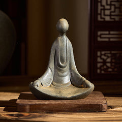 Iron Powder Sitting Formless Buddha Statue – front view on wooden base, warm room light, peaceful decor